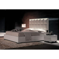 Side view of modern bed with leather headboard