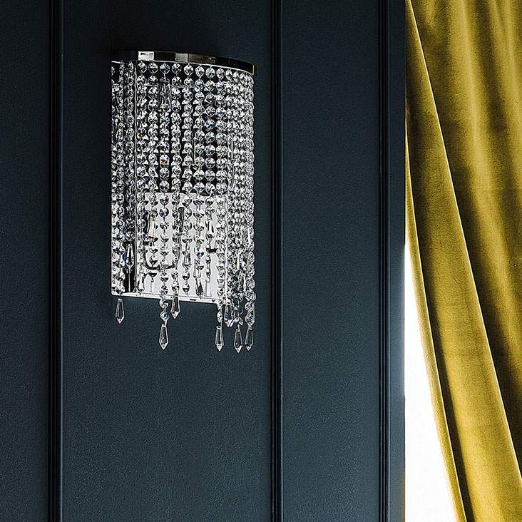 Italian chandelier with charcoal colored wall and gold drapes