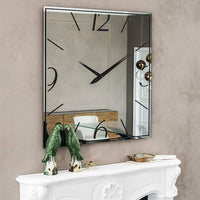 Squared mirrored Italian clock over white mantel