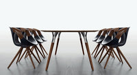 Italian wooden dining table surrounded by black chairs