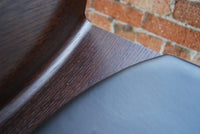 close view of bar stool leather and wood grain