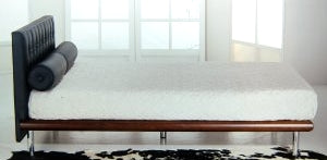 Modern Italian bed with black headboard and cushions