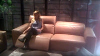 woman reclining on Italian leather sofa